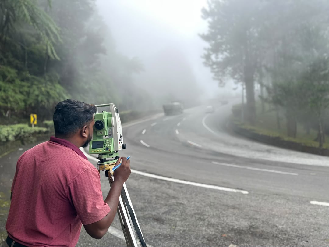 LOGAN surveyor with total station on mountain road